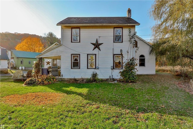 3479 Mango Dr, Lehigh Township, PA 18038 - rear view of property with a chimney and a lawn