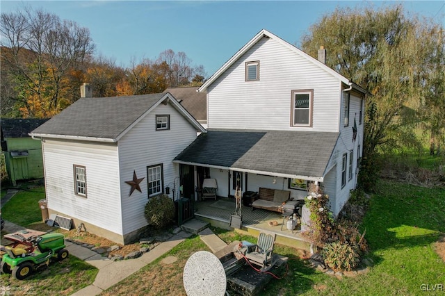 3479 Mango Dr, Lehigh Township, PA 18038 - rear view of house with a chimney, a yard, a shingled roof, and outdoor lounge area