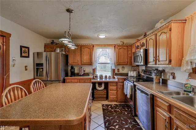 3479 Mango Dr, Lehigh Township, PA 18038 - kitchen with appliances with stainless steel finishes, brown cabinets, a sink, a kitchen island, and light tile patterned floors
