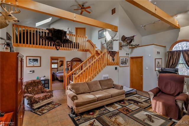 tiled living room featuring beamed ceiling, track lighting, high vaulted ceiling, and ceiling fan