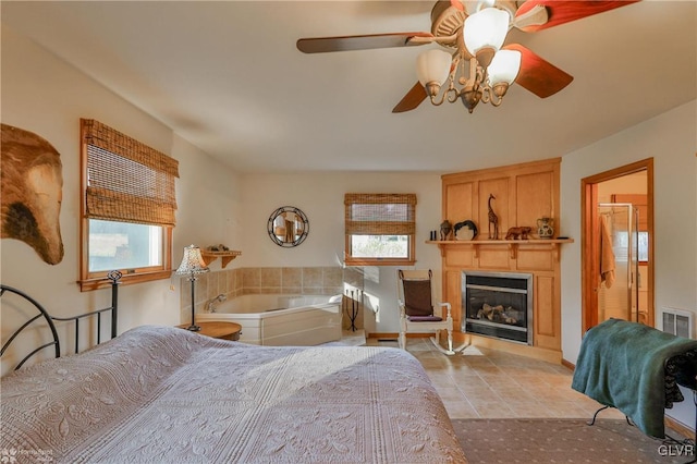 tiled bedroom with multiple windows and ceiling fan