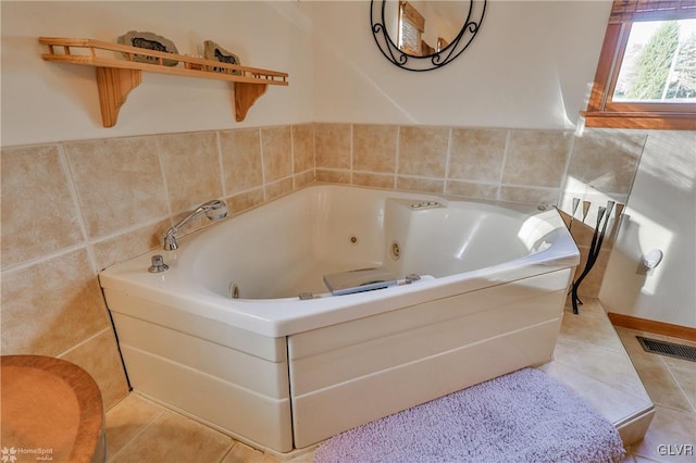 bathroom with tile patterned flooring and a washtub