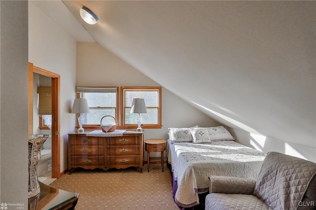 bedroom with light carpet and vaulted ceiling