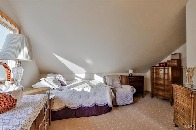 carpeted bedroom with lofted ceiling