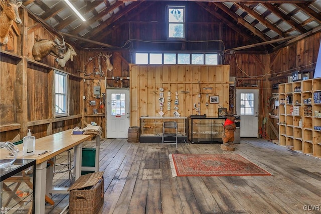 miscellaneous room featuring hardwood / wood-style floors, a wealth of natural light, and wooden walls