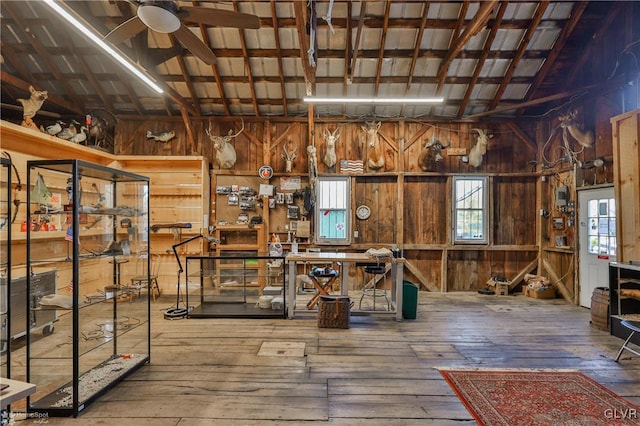 miscellaneous room featuring a workshop area, hardwood / wood-style flooring, ceiling fan, and lofted ceiling