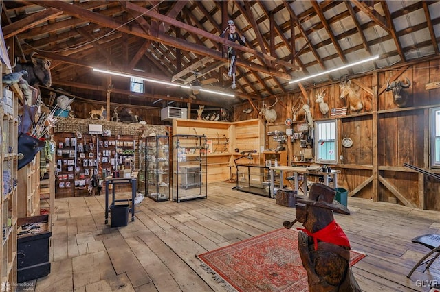 interior space featuring a workshop area and wooden walls