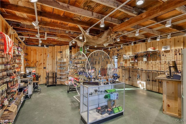 misc room with concrete floors and wooden walls