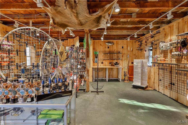 interior space with concrete flooring and wooden walls