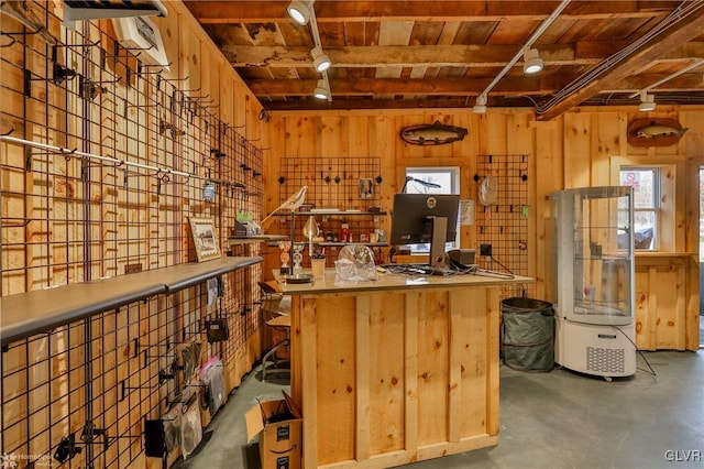 interior space with concrete floors and wood walls