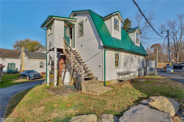 3479 Mango Dr, Lehigh Township, PA 18038 - view of side of property featuring metal roof, stairway, and driveway