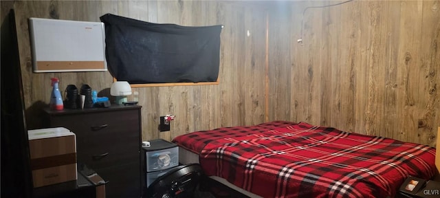 bedroom featuring wood walls