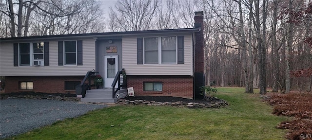 split foyer home with a front yard and a chimney