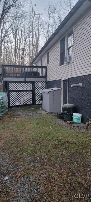 view of yard with cooling unit and a wooden deck