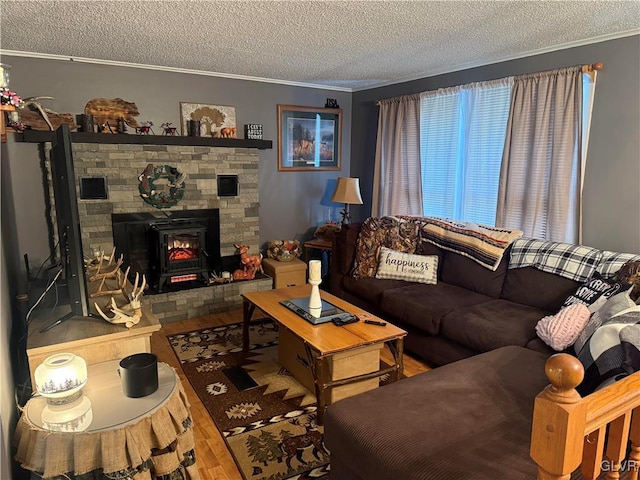 living area featuring a stone fireplace, crown molding, a textured ceiling, and wood finished floors