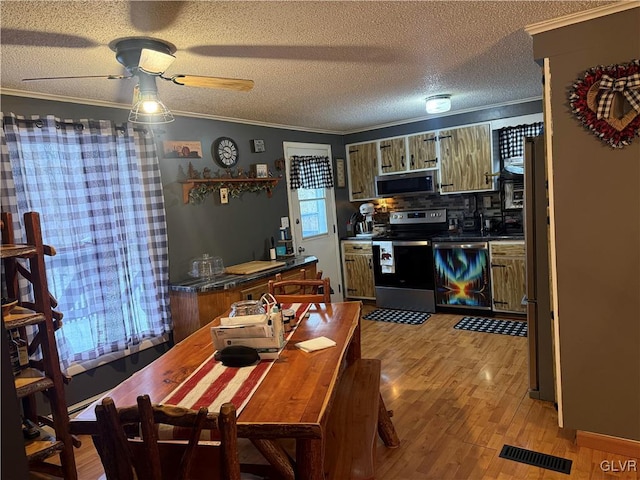 kitchen featuring visible vents, ornamental molding, and stainless steel appliances