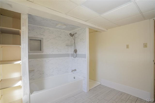 bathroom featuring hardwood / wood-style floors, a paneled ceiling, and shower / tub combination