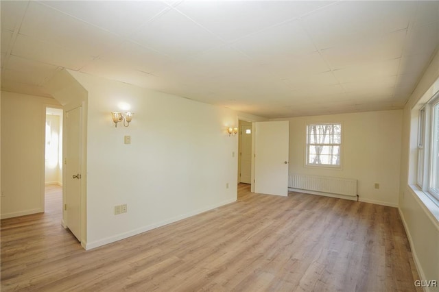 empty room featuring light hardwood / wood-style floors and radiator