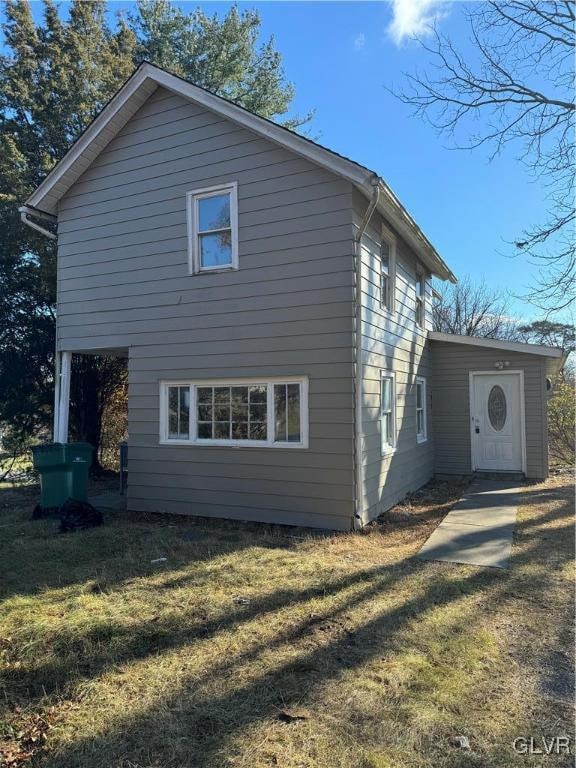 view of side of property with a lawn