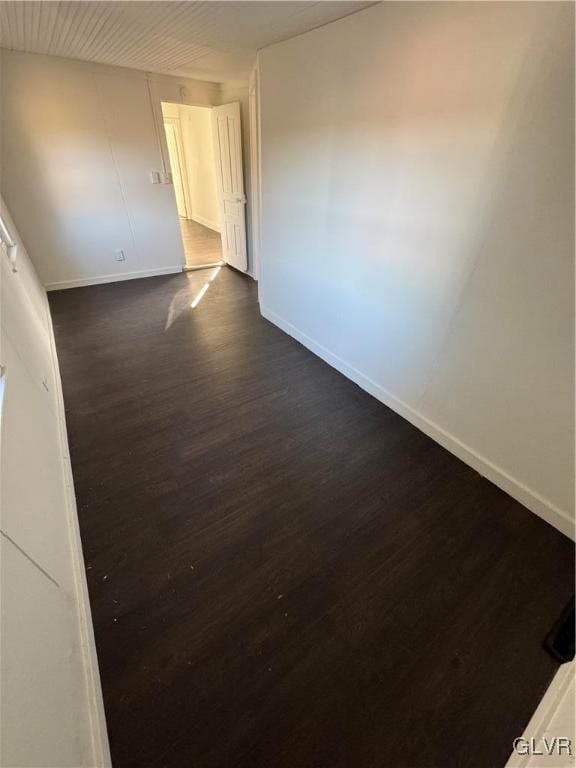 unfurnished room featuring dark hardwood / wood-style flooring