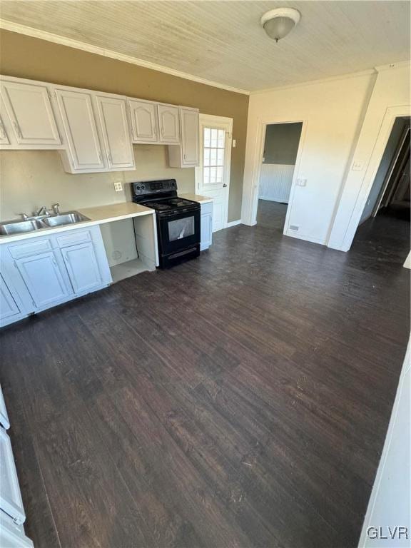 kitchen with black electric range oven, white cabinets, crown molding, sink, and dark hardwood / wood-style floors