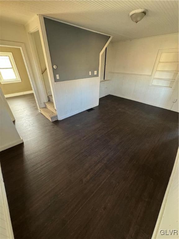 empty room with dark hardwood / wood-style floors