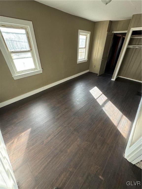 unfurnished bedroom featuring dark wood-type flooring