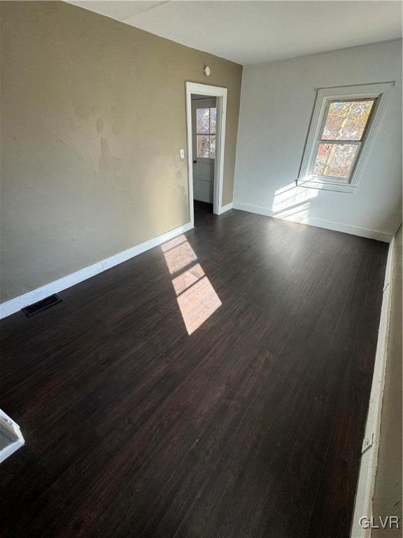 spare room with dark hardwood / wood-style flooring