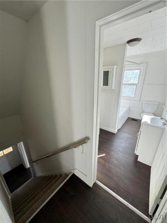 stairway featuring wood-type flooring