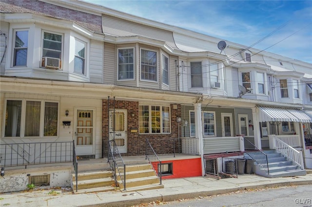 townhome / multi-family property featuring cooling unit and covered porch