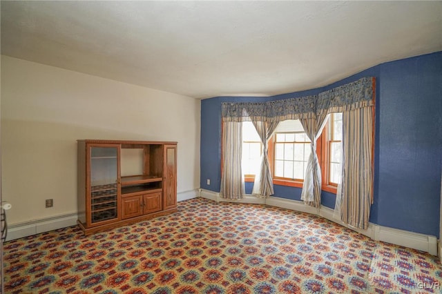 unfurnished living room featuring carpet floors and a baseboard radiator