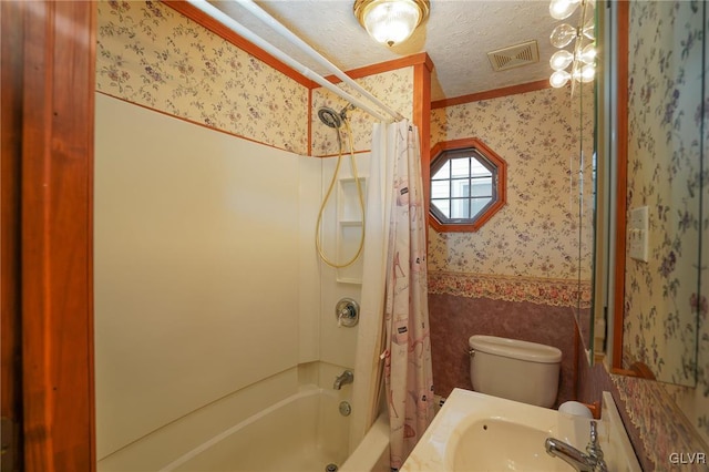 full bathroom with crown molding, sink, shower / bath combination with curtain, and toilet