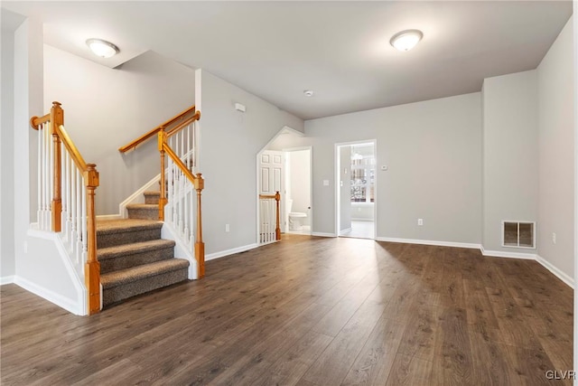 unfurnished living room with dark hardwood / wood-style flooring