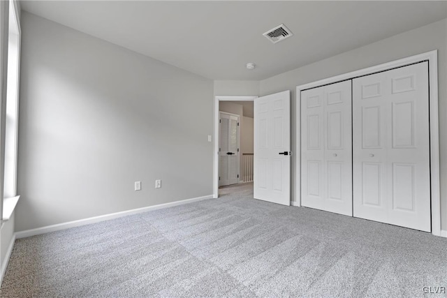 unfurnished bedroom with carpet and a closet