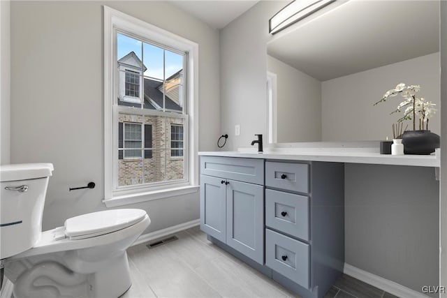 bathroom featuring vanity and toilet