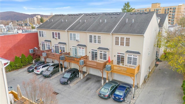 rear view of property with a mountain view and a garage