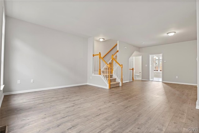 unfurnished living room with hardwood / wood-style flooring