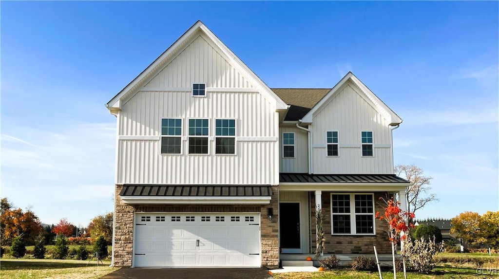 modern farmhouse style home featuring a garage and a front lawn