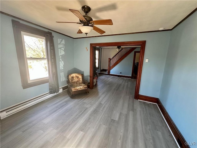 empty room featuring crown molding, a baseboard radiator, ceiling fan, and hardwood / wood-style flooring