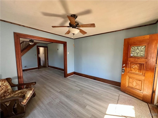 entrance foyer with crown molding, ceiling fan, and light hardwood / wood-style floors