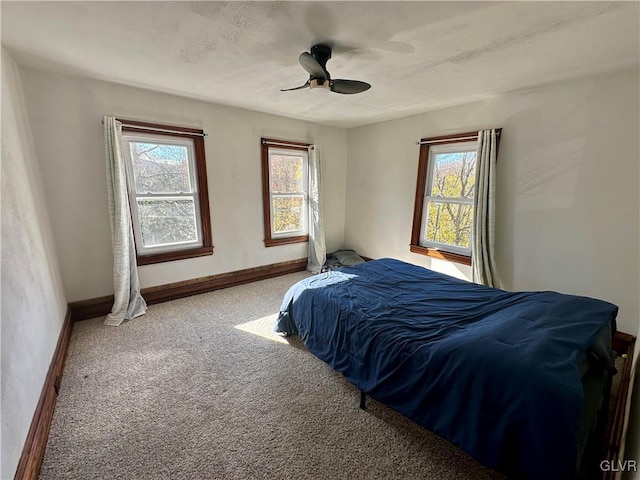 bedroom with ceiling fan and carpet flooring