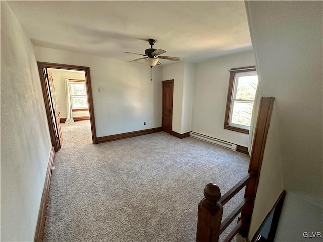 unfurnished room featuring a baseboard radiator, ceiling fan, and carpet flooring