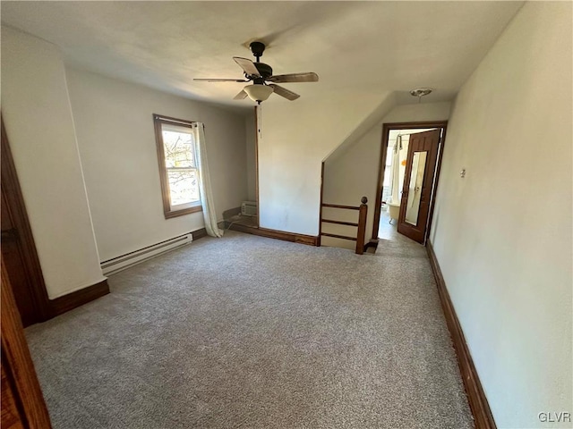 additional living space with ceiling fan, carpet floors, a wall unit AC, and a baseboard heating unit