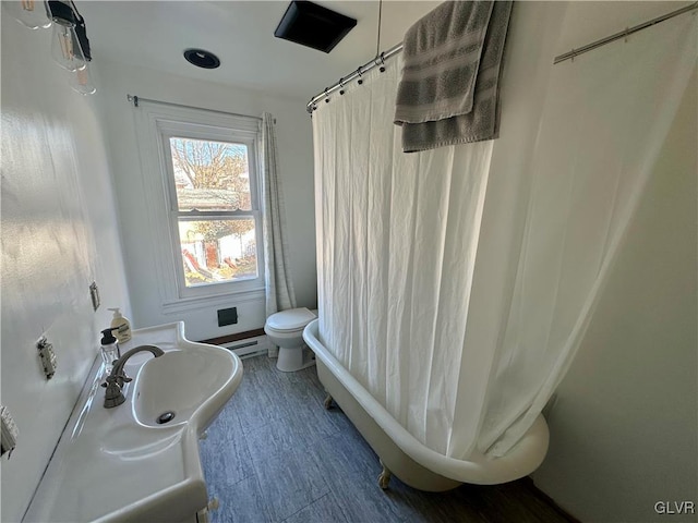 full bathroom with sink, shower / bath combo with shower curtain, and toilet