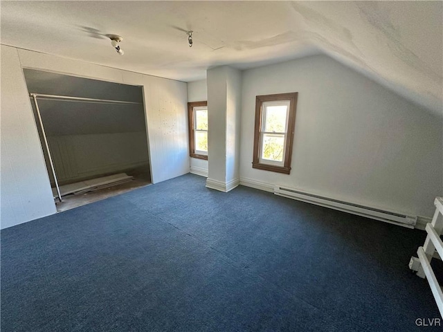 bonus room with vaulted ceiling, a baseboard heating unit, and carpet flooring