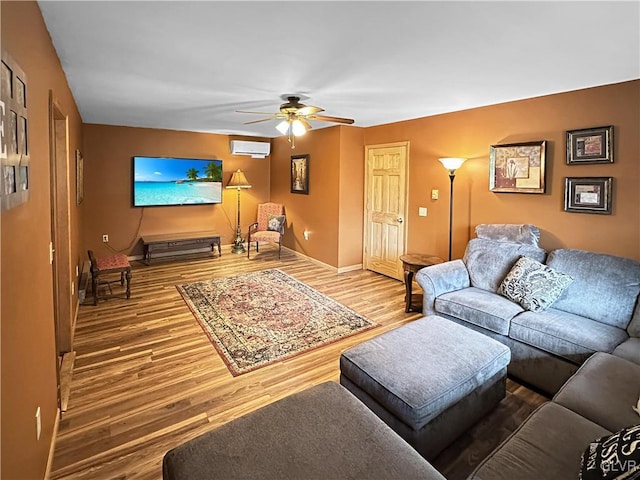 living room with an AC wall unit, ceiling fan, and wood-type flooring