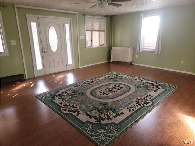 entrance foyer featuring hardwood / wood-style flooring, ceiling fan, and a baseboard heating unit