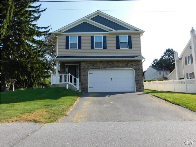 view of front of property featuring a front lawn and a garage