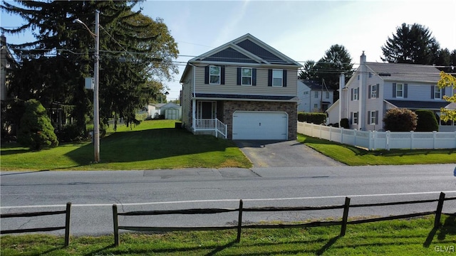 view of front of property featuring a front yard and a garage