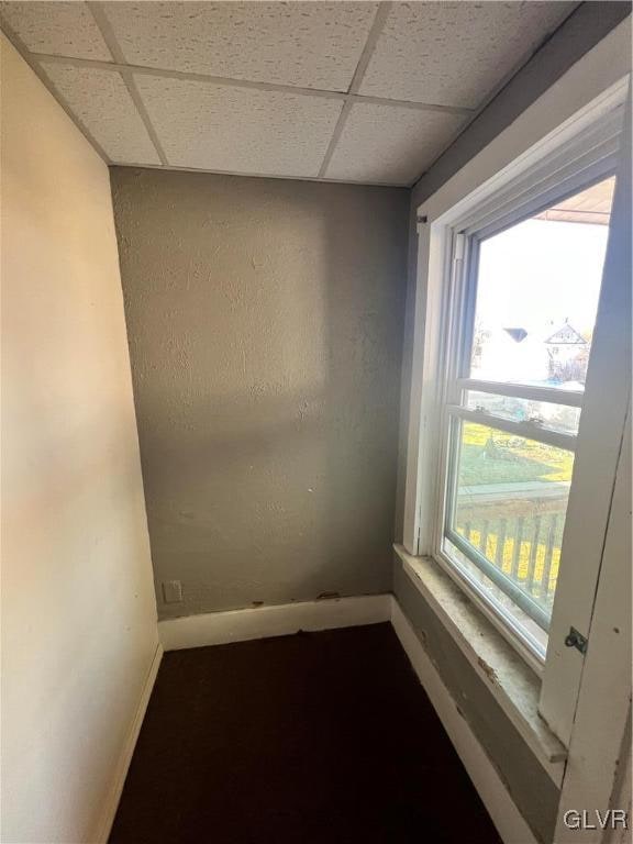 unfurnished room featuring a paneled ceiling